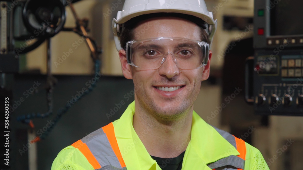 Young factory worker or engineer close up portrait in factory . Industry and engineering concept .