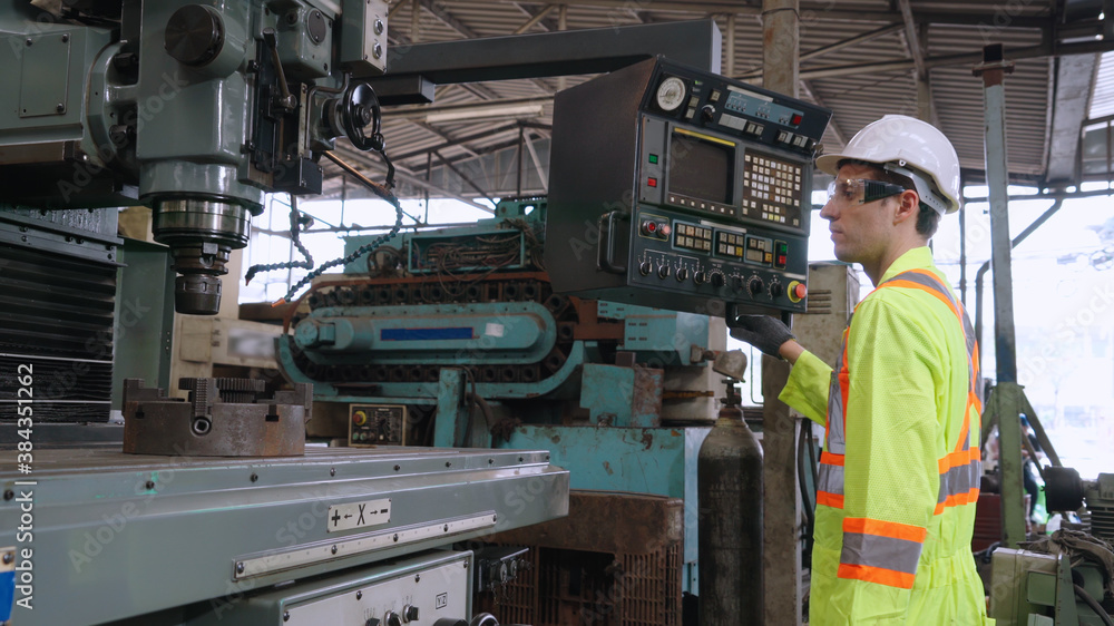 Smart factory worker using machine in factory workshop . Industry and engineering concept.