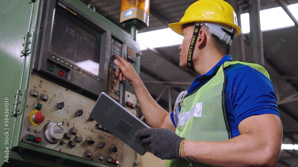 Smart factory worker using machine in factory workshop . Industry and engineering concept.