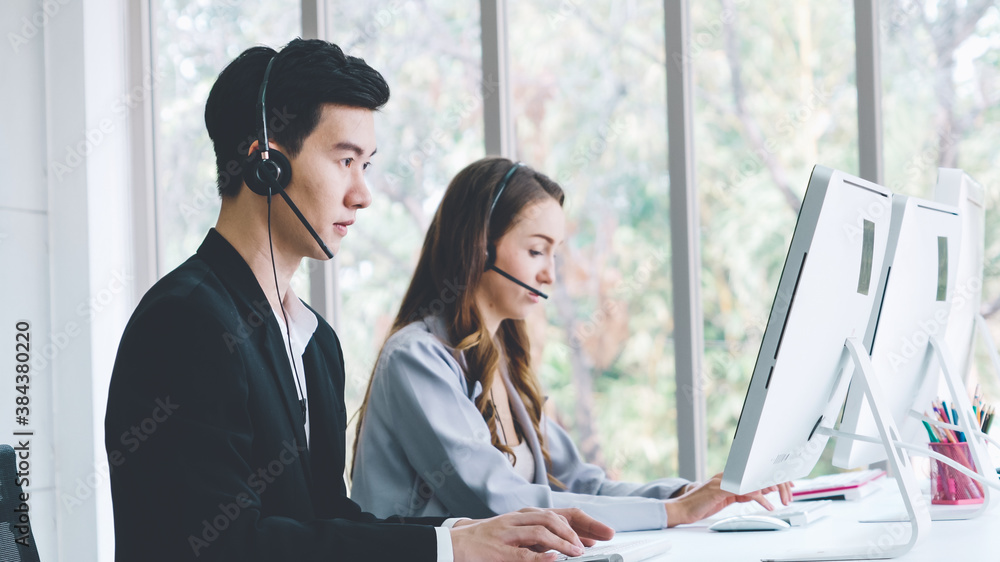 Business people wearing headset working in office to support remote customer or colleague. Call cent