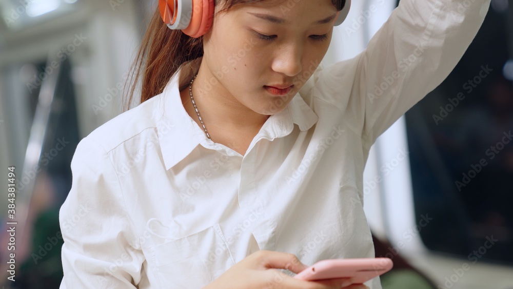 Young woman mobile phone on public train . Urban city lifestyle commuting concept .