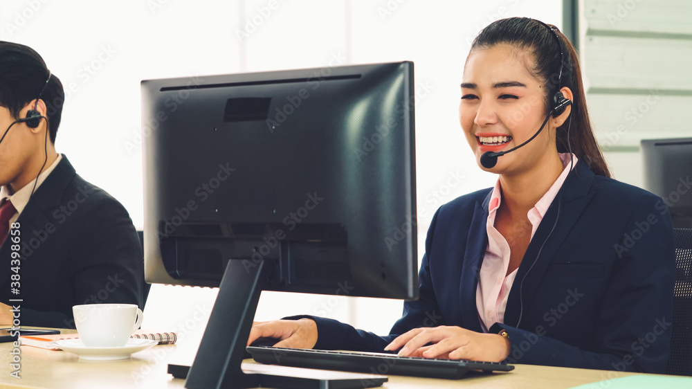 Business people wearing headset working in office to support remote customer or colleague. Call cent