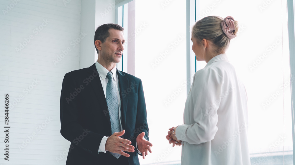 Two business people talk project strategy at office meeting room. Businessman discuss project planni