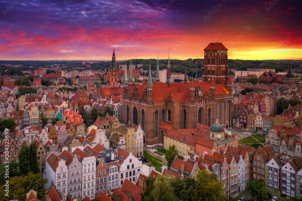 Beautiful sunset over the old town of Gdansk with City Hall and St. Mary Basilica, Poland