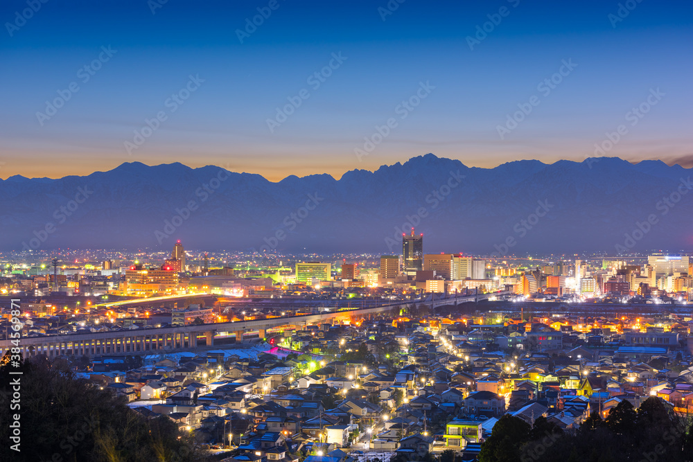 Toyama, Japan downtown city skyline with Tateyama Mountain.