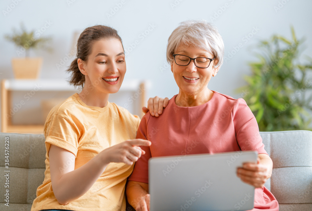 Young and senior women are using laptop