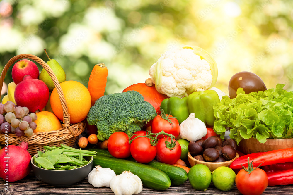 Group vegetables and Fruits Apples, grapes, oranges, and bananas in the wooden basket with carrots, 