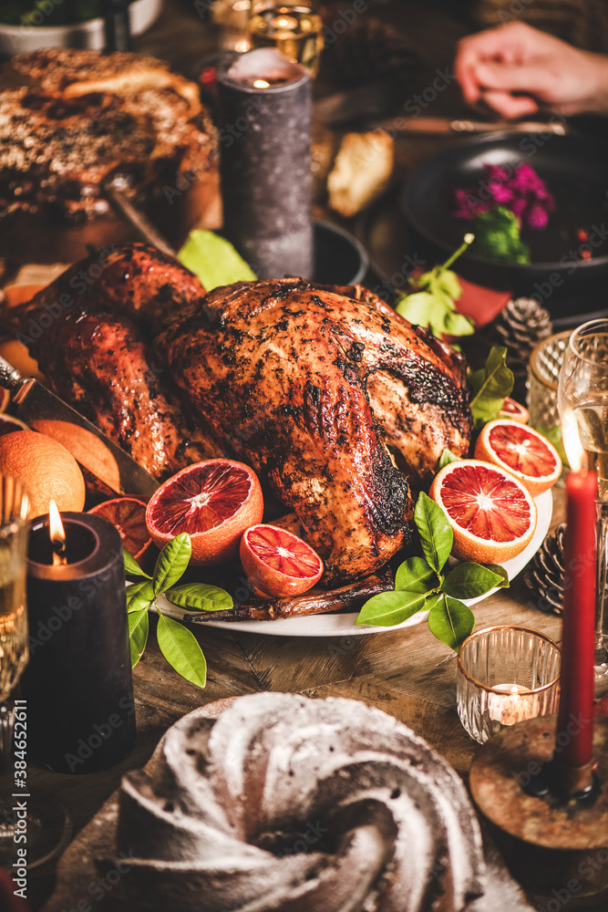 Family or friends celebrating Christmas or New Year. Holiday rustic wooden table with roasted turkey