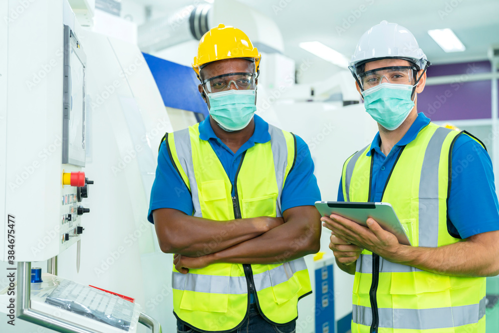 Professional engineering wearing mask discuss with engineer team in clean room machinery factory are