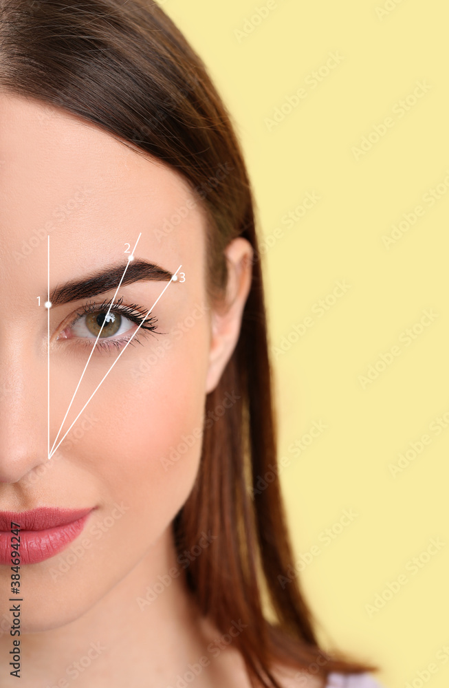 Young woman with beautiful eyebrows after correction procedure on color background, closeup