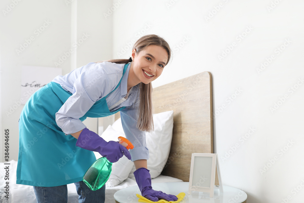 Young woman cleaning her flat