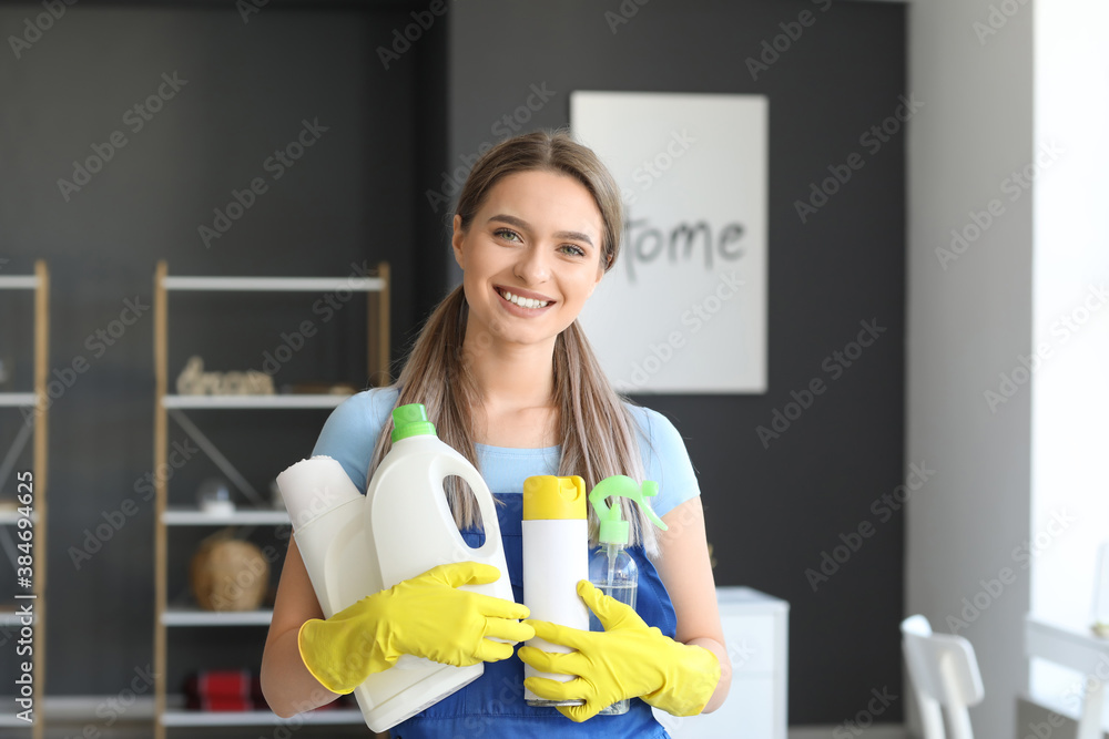 Young woman with cleaning supplies at home