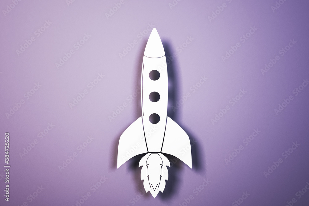 Toy white rocket on purple background.