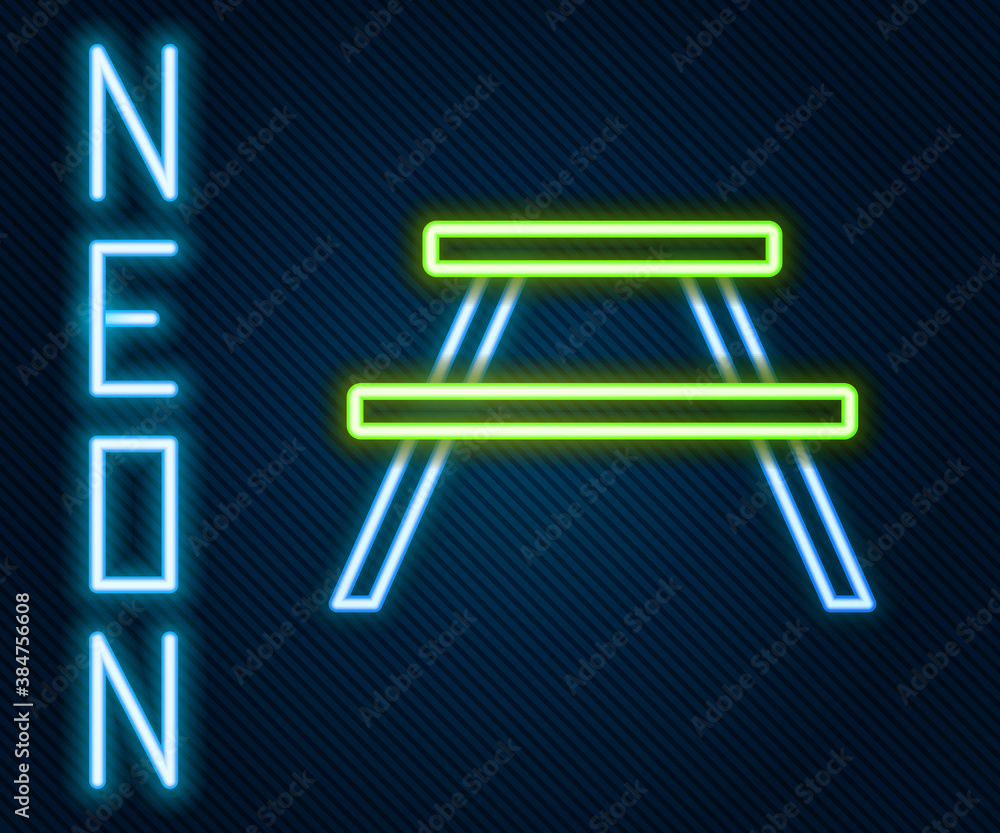 Glowing neon line Picnic table with benches on either side of the table icon isolated on black backg