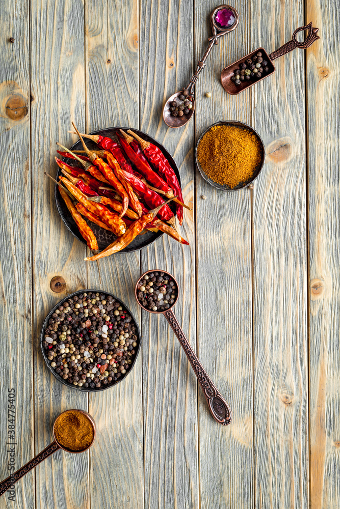 Spices and condiments in metal bowls and spoons. Overhead view