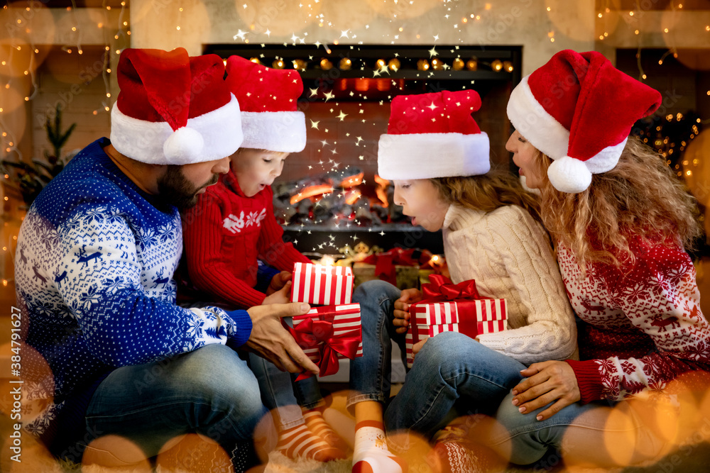 Happy family with children opening Christmas gift