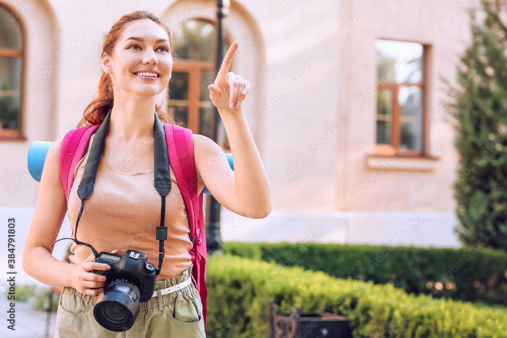 Female tourist with camera on city street