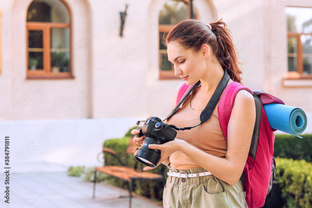 Female tourist with camera on city street