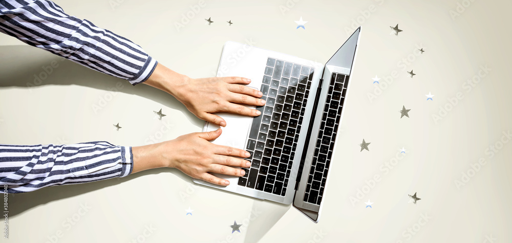 Person using a laptop computer with small stars from above