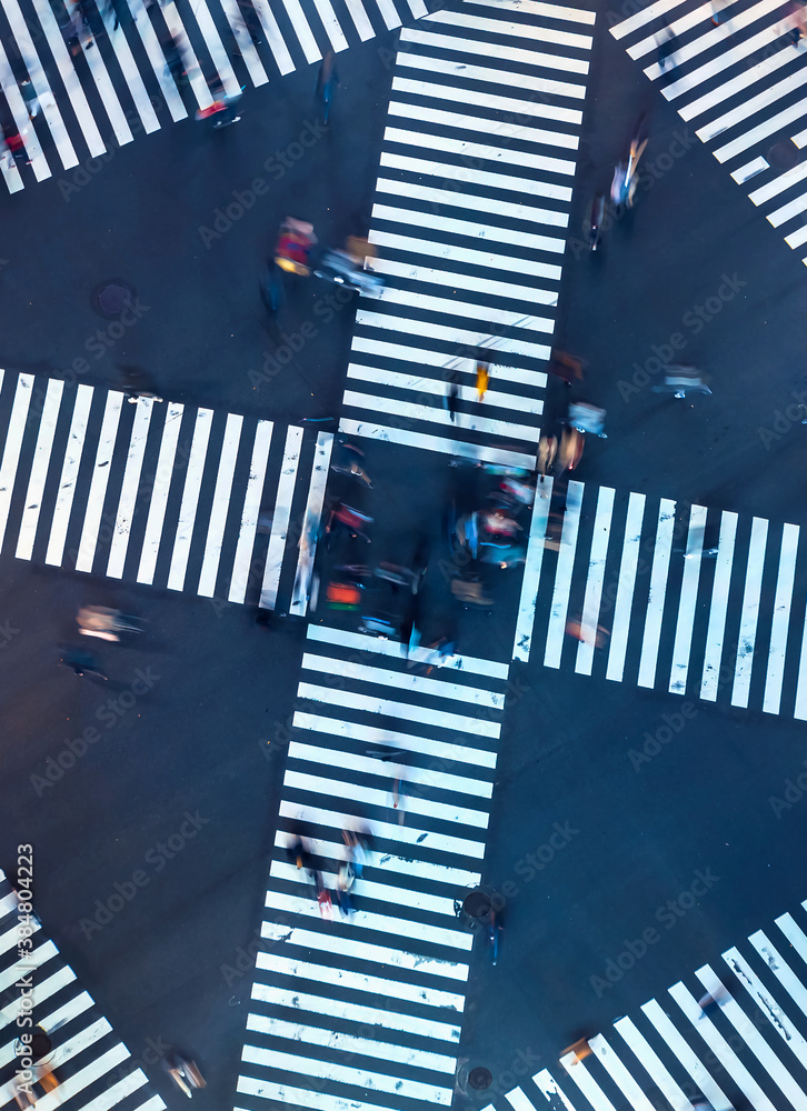 Traffic and people cross a busy intersection in Ginza, Tokyo