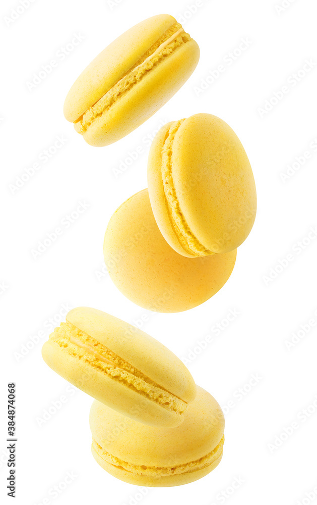 Isolated yellow macaroons. Five lemon or banana macaroons falling down over white background