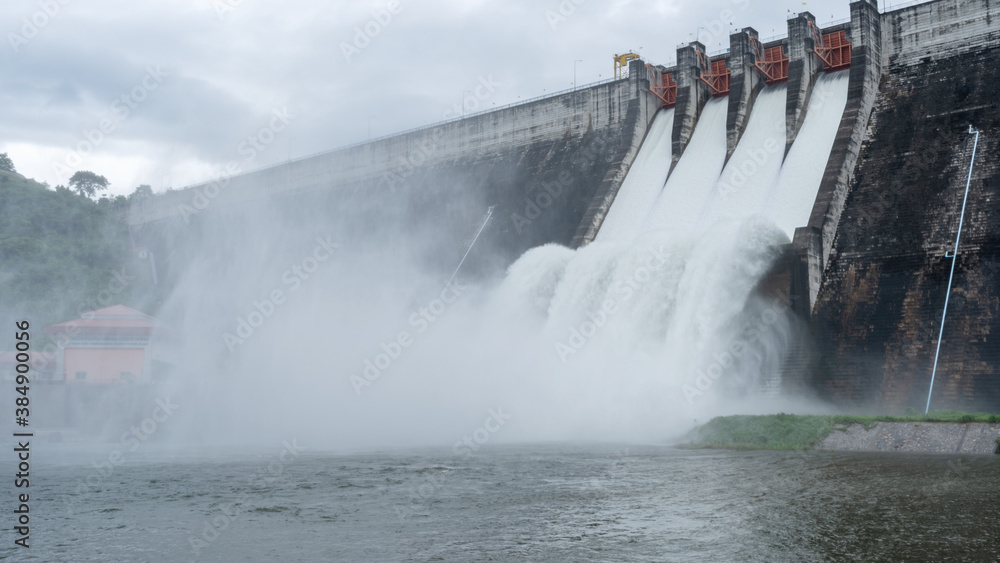 Water flowing over floodgates of a dam,Khun Dan Prakan Chon Dam in Nakhon Nayok province Thailand Da