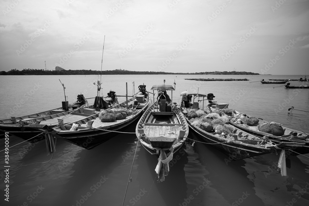 Longtail fishing boats at fishing village in Thailand Black and White.