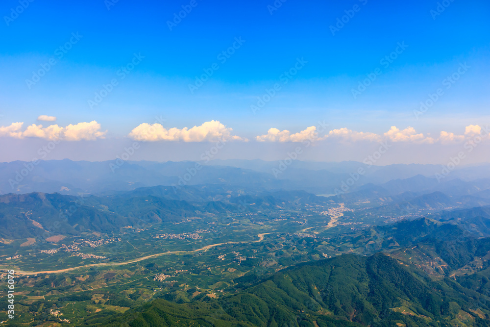 Aerial view above the clouds and mountain peaks on a sunny day.mountain view from airplane.