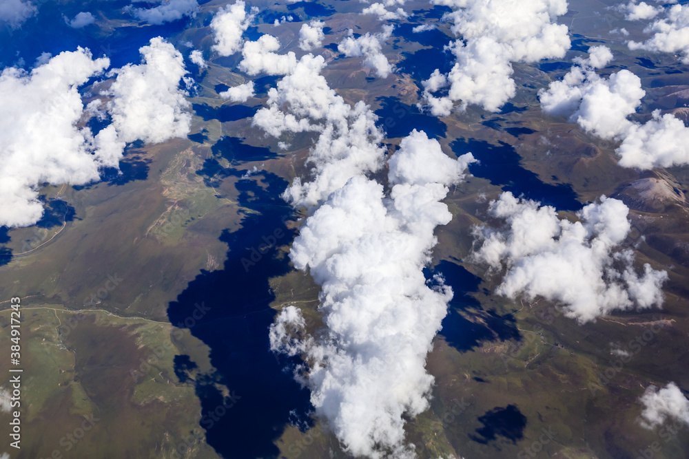 Aerial view above the clouds and mountain peaks on a sunny day.mountain view from airplane.