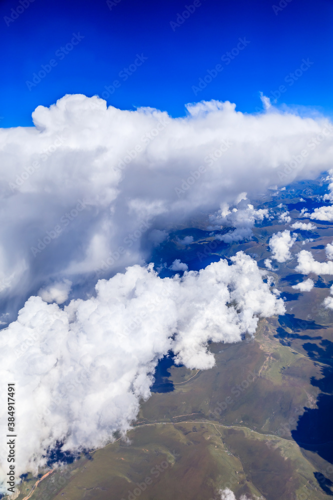 Aerial view above the clouds and mountain peaks on a sunny day.mountain view from airplane.