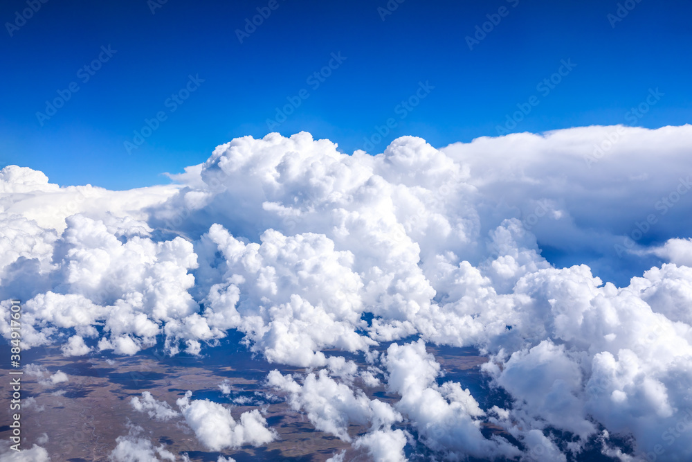 Aerial view above the clouds and mountain peaks on a sunny day.mountain view from airplane.