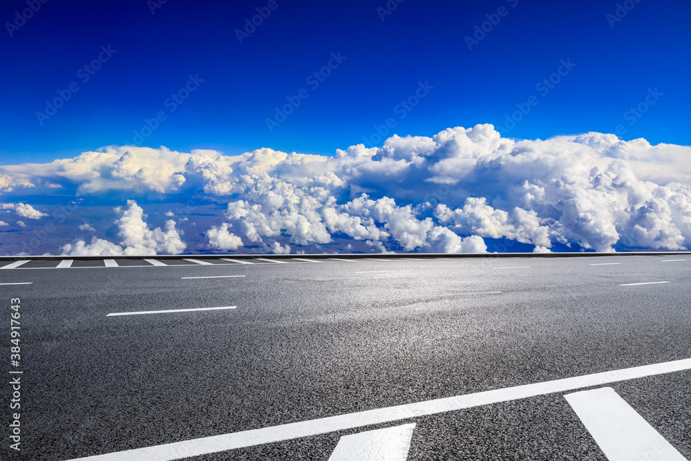 Empty asphalt road and blue sky with white clouds scenery.