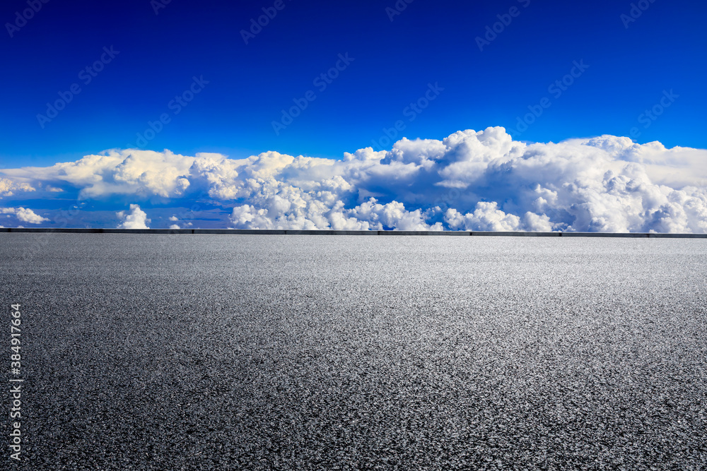 Empty asphalt road and blue sky with white clouds scenery.