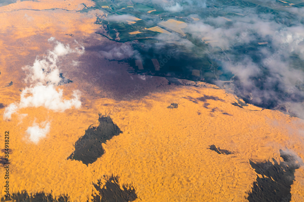 Aerial view above the clouds and mountain peaks on a sunny day.mountain view from airplane.