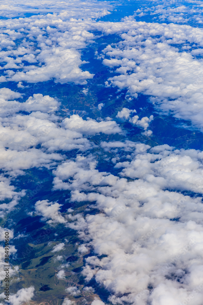 Aerial view above the clouds and mountain peaks on a sunny day.mountain view from airplane.