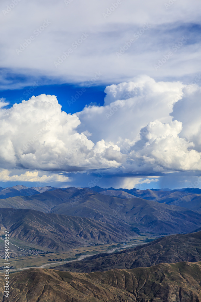 Aerial view above the clouds and mountain peaks on a sunny day.mountain view from airplane.