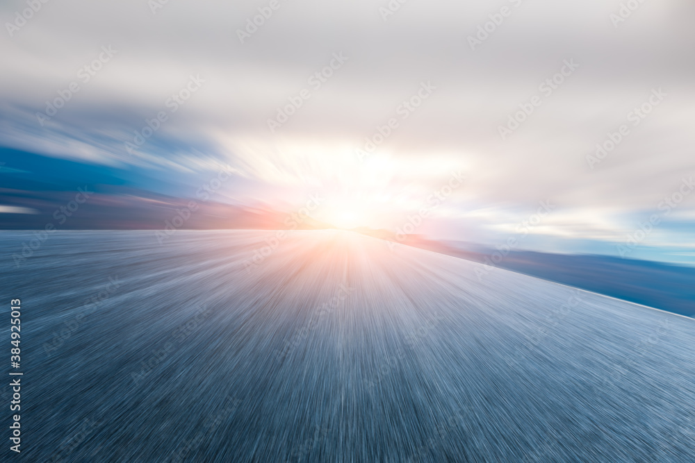 Motion blurred asphalt road and mountain with cloud scenery.