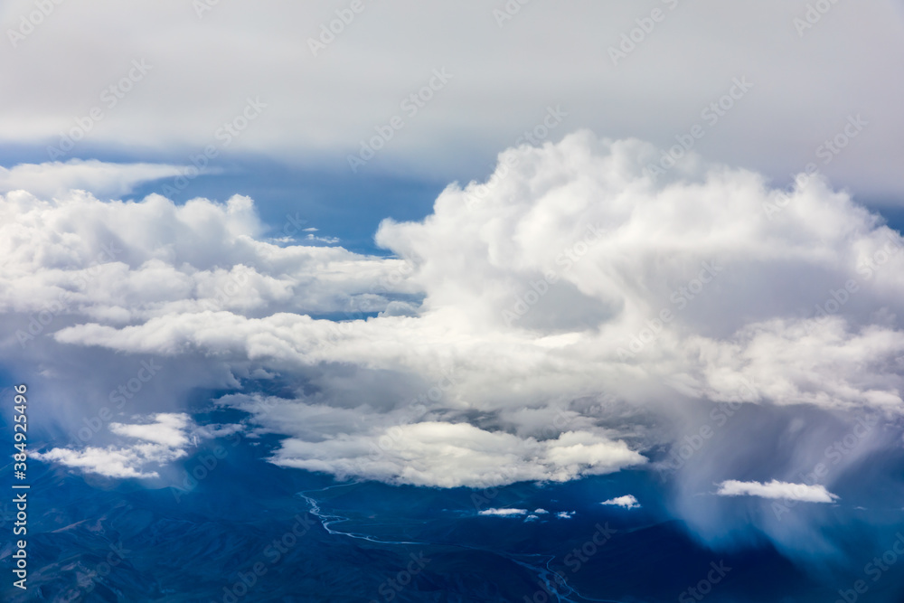 Aerial view above the clouds and mountain peaks on a sunny day.mountain view from airplane.