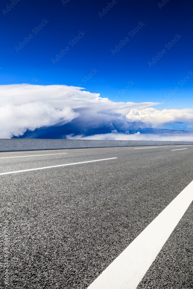 Empty asphalt road and blue sky with white clouds scenery.