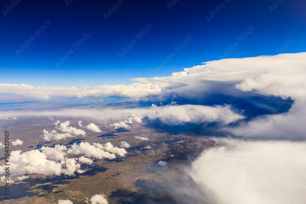 Aerial view above the clouds and mountain peaks on a sunny day.mountain view from airplane.