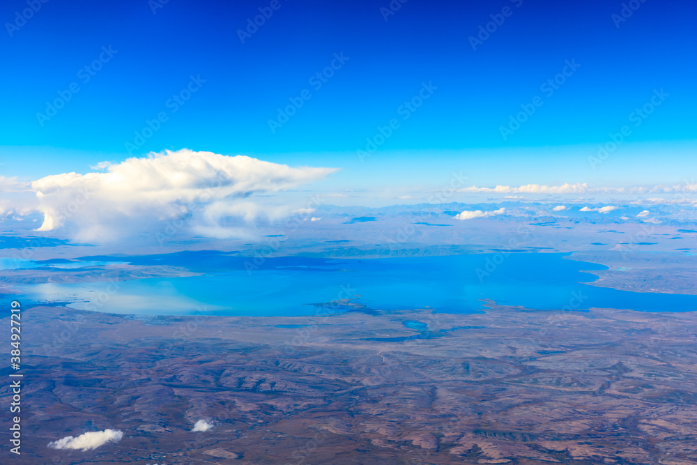 Aerial view above the clouds and mountain peaks on a sunny day.mountain view from airplane.