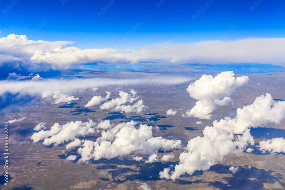 Aerial view above the clouds and mountain peaks on a sunny day.mountain view from airplane.