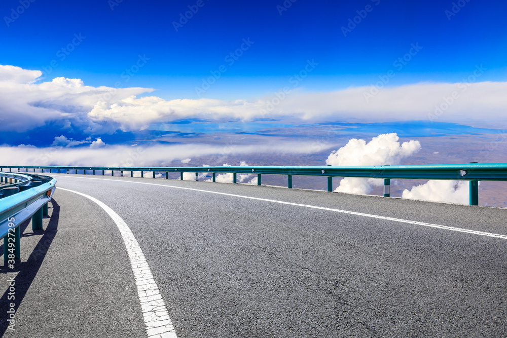 Empty asphalt road and blue sky with white clouds scenery.