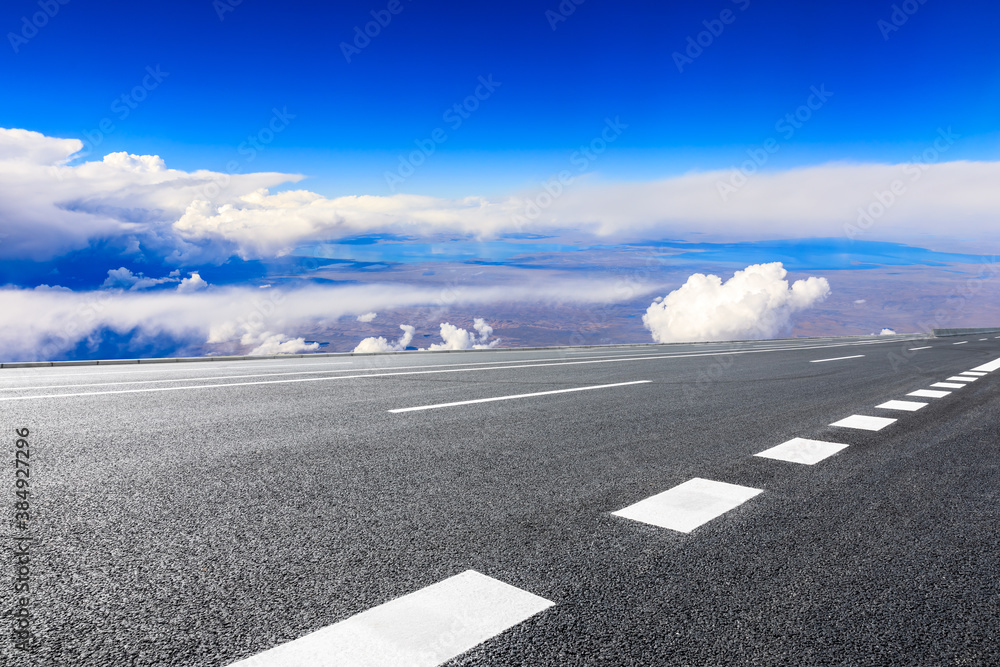 Empty asphalt road and blue sky with white clouds scenery.