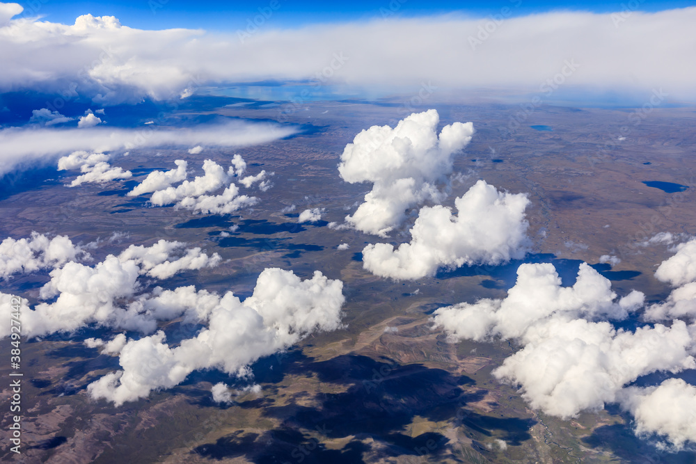 Aerial view above the clouds and mountain peaks on a sunny day.mountain view from airplane.