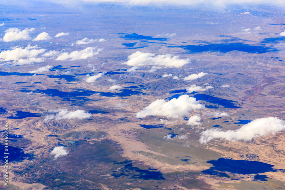 Aerial view above the clouds and mountain peaks on a sunny day.mountain view from airplane.