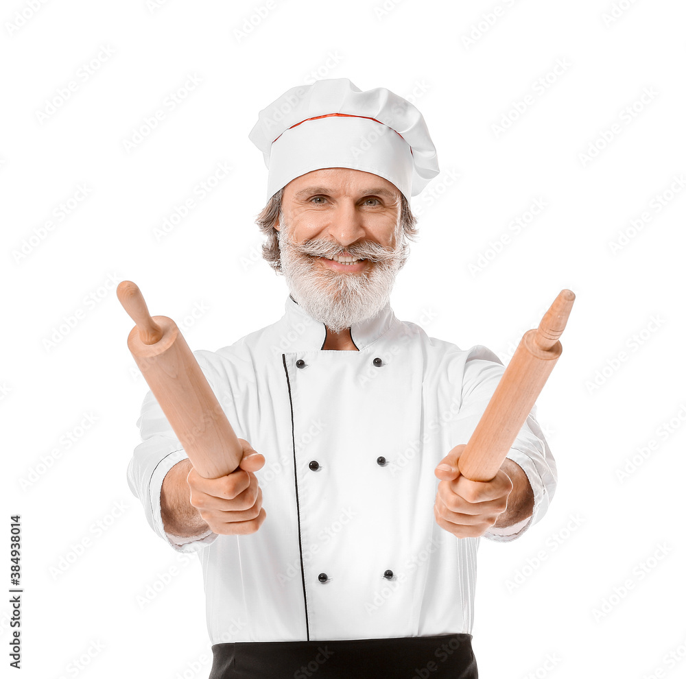 Mature male chef with rolling pins on white background