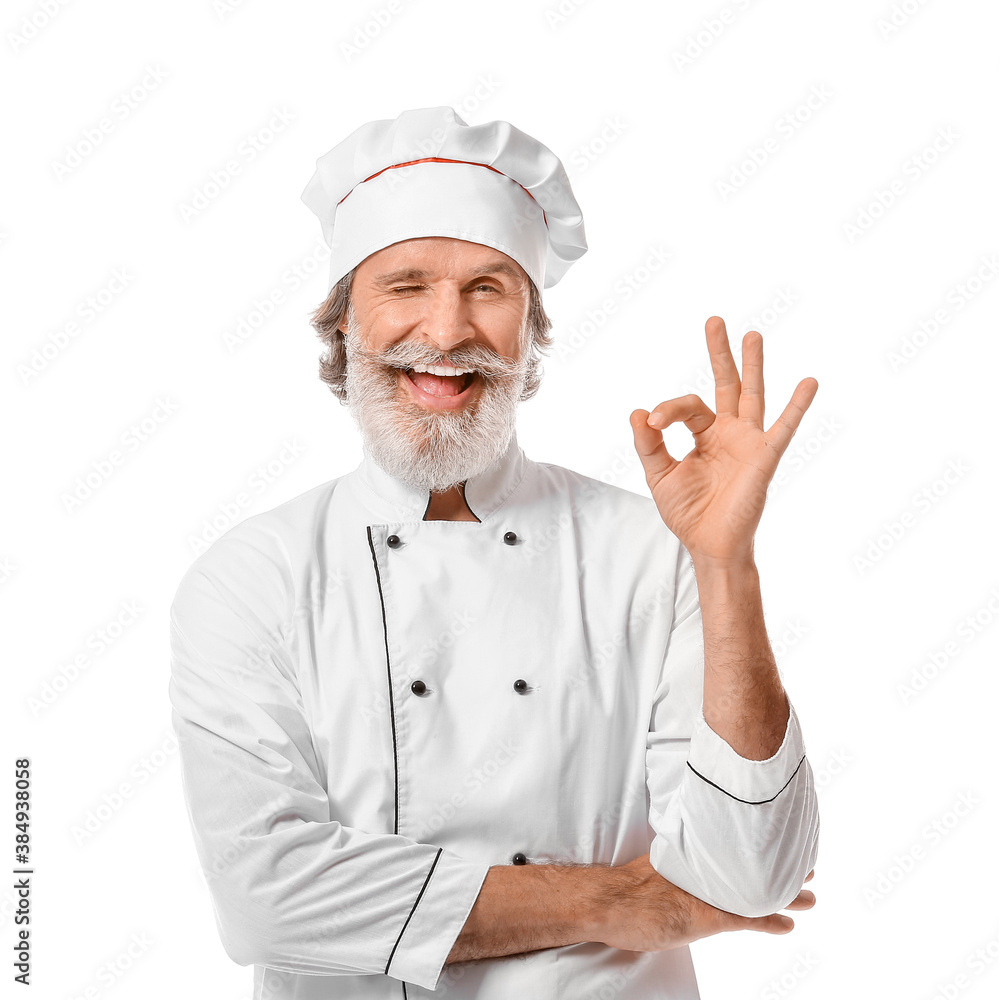 Mature male chef showing OK on white background