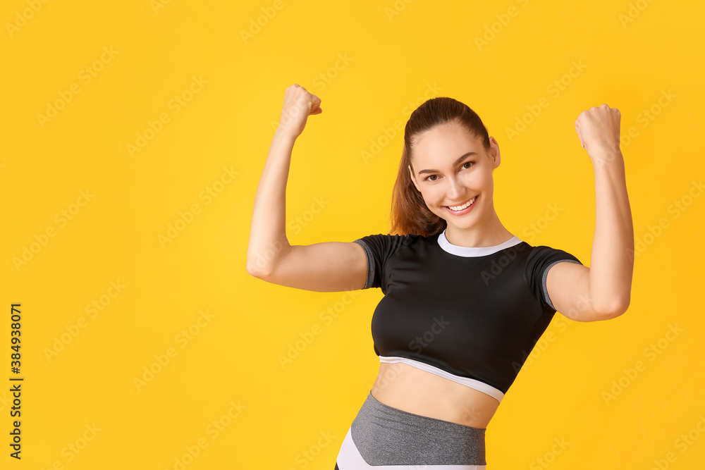 Happy sporty young woman on color background. Concept of goal achievement