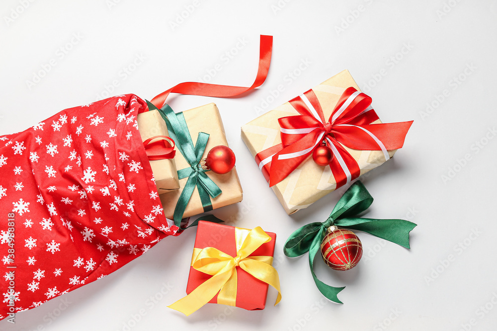 Santa bag with gifts on light background